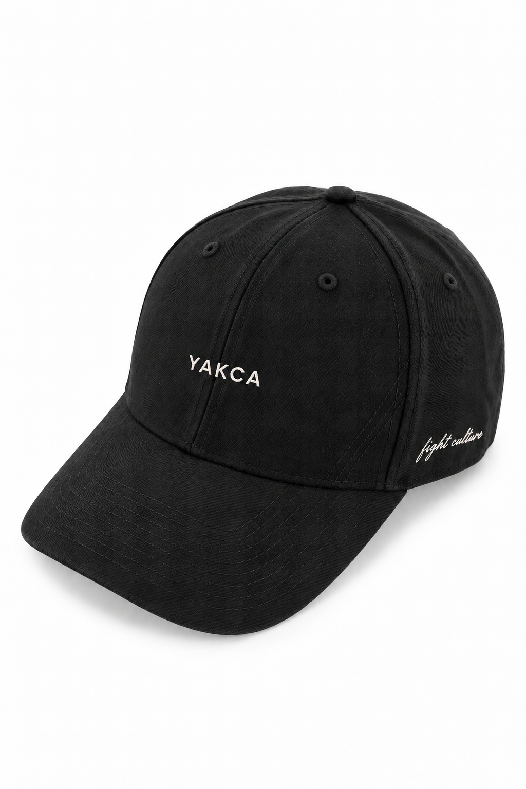 YAKCA CORE washed-black six-panel cap with small off-white YAKCA front embroidery, tonal curved stitching and fight culture script on the side