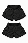 YAKCA FIGHTWEAR black Muay Thai shorts with small white YAKCA logos, plain elasticated waistband and lightweight fabric with a subtle sheen, front and back views