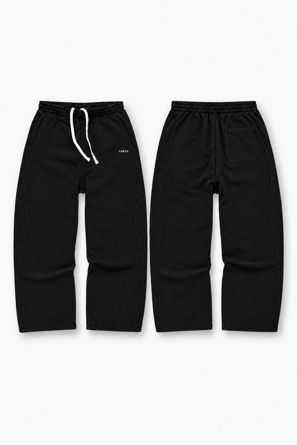 YAKCA CORE black oversized sweatpants with curved panel seams and ivory drawstrings, front and back views