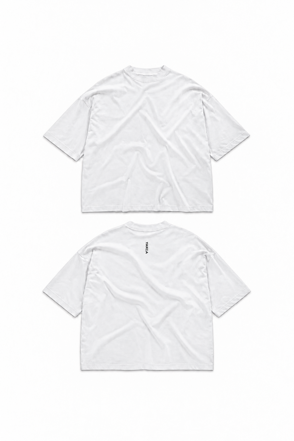 YAKCA CORE pure white oversized T-shirt, plain front and small vertical black YAKCA logo centred on the upper back