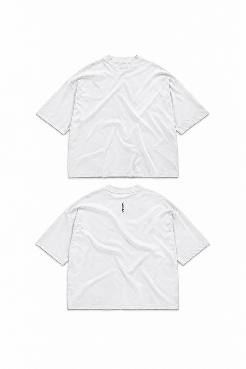 YAKCA CORE pure white oversized T-shirt, plain front and small vertical black YAKCA logo centred on the upper back